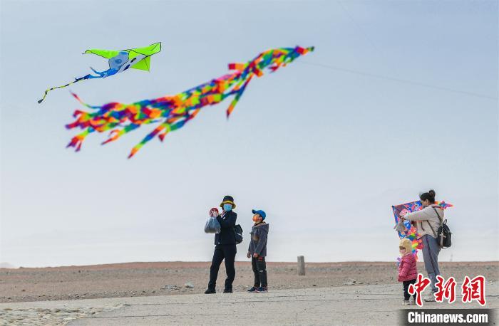 圖為孩童在父母的陪伴下放風(fēng)箏?！⊥醣筱y 攝