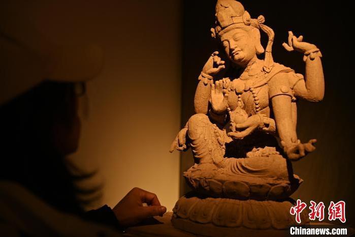 圖為季茂杰觀察自己創(chuàng)作的敦煌木雕。李亞龍 攝