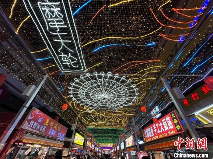 圖為明清街夜市燈光點(diǎn)亮具有武威文化元素的“摩天輪”彩燈?！〈魑牟?攝</p><p>